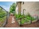 Fenced backyard with garden beds, walkway, and a small deck at 429 Carolina Cir, Durham, NC 27707