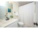 Bathroom with white vanity, sink, tiled floors, and a shower with a patterned curtain for privacy at 429 Carolina Cir, Durham, NC 27707