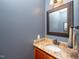Bathroom features a granite countertop with an oval sink, vanity mirror, and gray walls at 429 Carolina Cir, Durham, NC 27707