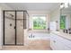 Bathroom with a soaking tub, glass shower, double vanity, neutral tones, and a bright window at 429 Carolina Cir, Durham, NC 27707