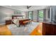 Bedroom with hardwood floors, ceiling fan, area rug, and large windows that let in natural light at 429 Carolina Cir, Durham, NC 27707