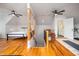 Multi-use bonus room with hardwood floors, seating, and stair access at 429 Carolina Cir, Durham, NC 27707