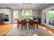 Elegant dining room featuring hardwood floors, a large window, and stylish light fixtures at 429 Carolina Cir, Durham, NC 27707