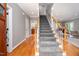 Inviting foyer with hardwood floors, a staircase with carpeted treads, and a glimpse of the kitchen at 429 Carolina Cir, Durham, NC 27707