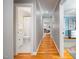 Hallway featuring hardwood floors leading to a bathroom and bedroom providing a seamless transition at 429 Carolina Cir, Durham, NC 27707