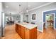 Open kitchen featuring a large center island, adjacent to the dining room at 429 Carolina Cir, Durham, NC 27707