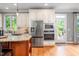 Well-lit kitchen boasting stainless steel appliances and direct access to the patio at 429 Carolina Cir, Durham, NC 27707