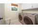 Functional laundry room featuring stainless steel appliances, bright light and ample storage at 429 Carolina Cir, Durham, NC 27707