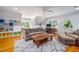 Open-concept living room with comfortable seating, custom built-ins, and a stylish area rug at 429 Carolina Cir, Durham, NC 27707