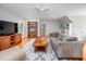 Inviting living room with hardwood floors, a TV, and a comfortable gray sofa at 429 Carolina Cir, Durham, NC 27707