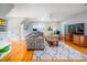 Spacious living room with a grey sofa, hardwood floors, and bright natural light at 429 Carolina Cir, Durham, NC 27707