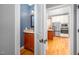 View from hallway into kitchen and the adjacent powder room with granite vanity at 429 Carolina Cir, Durham, NC 27707