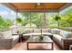 Relaxing screened-in porch with wicker furniture and tiled floor overlooking lush backyard at 429 Carolina Cir, Durham, NC 27707