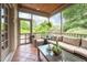Inviting screened porch features wicker furniture, tiled floor, and views of the landscaped backyard at 429 Carolina Cir, Durham, NC 27707