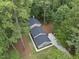 Aerial view of the house showcasing its location surrounded by lush trees at 4301 Azalea Dr, Raleigh, NC 27612