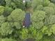 Aerial view of the home's roof among treetops, nestled in a lush green environment at 4301 Azalea Dr, Raleigh, NC 27612