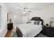 Primary bedroom with natural light, plush bed with decorative pillows, and access to an en-suite bathroom at 4301 Azalea Dr, Raleigh, NC 27612