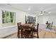 Bright dining area features a wood table set for a game, complemented by a modern light fixture and shelves at 4301 Azalea Dr, Raleigh, NC 27612