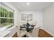 Cozy dining area with glass table and tufted chairs offers a charming view of the outdoors at 4301 Azalea Dr, Raleigh, NC 27612