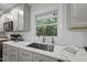 Bright kitchen features a stainless steel sink and faucet, plus a view of the outside through the window at 4301 Azalea Dr, Raleigh, NC 27612