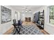 Open-concept living area with an area rug, a ceiling fan, and an adjacent dining space at 4301 Azalea Dr, Raleigh, NC 27612