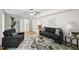 Bright living room with a patterned rug, comfortable seating, and a view into the next room at 4301 Azalea Dr, Raleigh, NC 27612