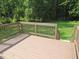 Wooden deck overlooking a large yard surrounded by green trees and grass at 440 Montgomery Rd, Franklinton, NC 27525