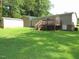 This property features a spacious backyard with a wooden deck, storage building, and plenty of green grass at 440 Montgomery Rd, Franklinton, NC 27525