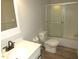 Well-lit bathroom with a vanity, toilet, and shower-tub with sliding glass doors at 440 Montgomery Rd, Franklinton, NC 27525