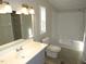 Bright bathroom featuring a vanity, toilet, and shower-tub combination at 440 Montgomery Rd, Franklinton, NC 27525