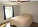 Cozy bedroom with a ceiling fan, a window with a view, and warm-toned laminate flooring at 440 Montgomery Rd, Franklinton, NC 27525