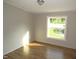 Simple bedroom with a large window providing natural light and wood-look flooring at 440 Montgomery Rd, Franklinton, NC 27525
