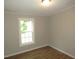 Cozy room featuring laminate flooring and a window with outdoor views at 440 Montgomery Rd, Franklinton, NC 27525