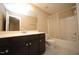 Bathroom featuring a shower-tub combo, white toilet, vanity and a large mirror at 4416 Walker Hallow St, Raleigh, NC 27616