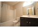 Bathroom featuring a shower-tub combo, white toilet, vanity and a large mirror at 4416 Walker Hallow St, Raleigh, NC 27616