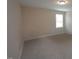 Cozy bedroom with plush carpeting and natural light from the window at 4416 Walker Hallow St, Raleigh, NC 27616