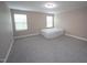 Empty bedroom featuring neutral walls, carpet flooring, and windows offering natural light at 4416 Walker Hallow St, Raleigh, NC 27616