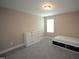 Bedroom with a sleek white dresser and bed featuring under-bed storage at 4416 Walker Hallow St, Raleigh, NC 27616