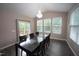 This dining room has a modern chandelier, large windows, and a sliding glass door to an outdoor deck at 4416 Walker Hallow St, Raleigh, NC 27616
