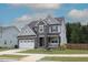 Beautiful home with stone accents, a two-car garage, and manicured lawn at 4416 Walker Hallow St, Raleigh, NC 27616