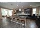 Staged kitchen boasts dark wood cabinets, granite countertops, and a spacious island at 4416 Walker Hallow St, Raleigh, NC 27616