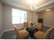 Inviting living room with a large window and comfortable seating arrangement at 4416 Walker Hallow St, Raleigh, NC 27616