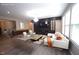 Staged living room with gray floors, white sofa and built-in entertainment center at 4416 Walker Hallow St, Raleigh, NC 27616
