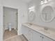 Bathroom with dual sinks, white cabinets and marble countertop at 4622 Ludwell Branch Ct, Raleigh, NC 27612
