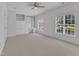 This bedroom features built-in shelving, a ceiling fan, and carpet flooring at 4622 Ludwell Branch Ct, Raleigh, NC 27612