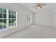Bedroom featuring a ceiling fan and a large window that provides natural light at 4622 Ludwell Branch Ct, Raleigh, NC 27612