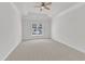 This cozy bedroom features neutral carpet and a ceiling fan at 4622 Ludwell Branch Ct, Raleigh, NC 27612