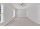This bedroom features a ceiling fan and a large window at 4622 Ludwell Branch Ct, Raleigh, NC 27612