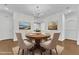 Charming dining room boasts a round table with seating for four, elegant decor, and hardwood floors at 4622 Ludwell Branch Ct, Raleigh, NC 27612