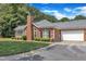 Beautiful brick home with attached garage, manicured lawn, and mature trees at 4622 Ludwell Branch Ct, Raleigh, NC 27612